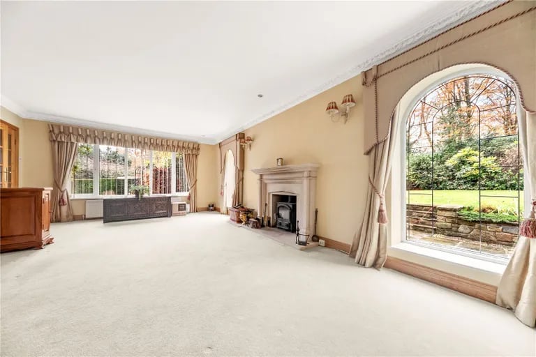 The property features accommodation in excess of 4,000 square feet, including this open lounge with fireplace.