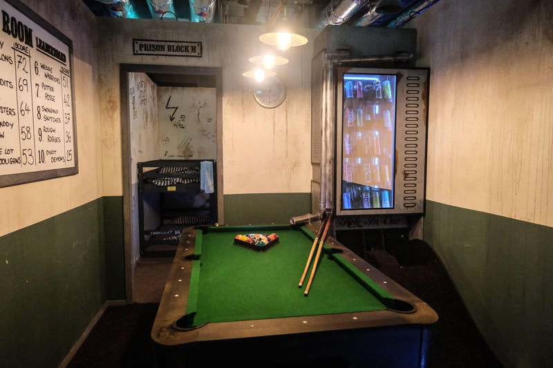 This isn't a pool table, but one of the holes in Tenpins prison themed mini-golf course where visitors play 10 holes to escape (there is also a regular pool table in the main lobby).