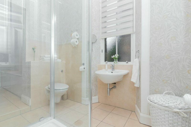 The stylish and modern family bathroom has a separate bath and shower. 