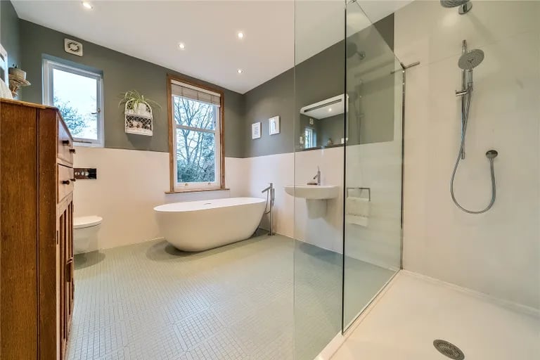 The house bathroom is a large suite with bathtub and walk-in shower.