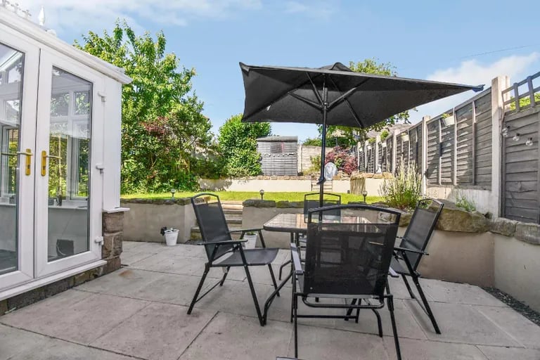 The patio overlooks the large garden and is ideal for alfresco dining and entertaining.