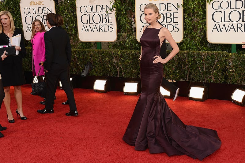 For her Golden Globes debut in 2013, Taylor Swift chose an aubergine coloured Donna Karan dress.