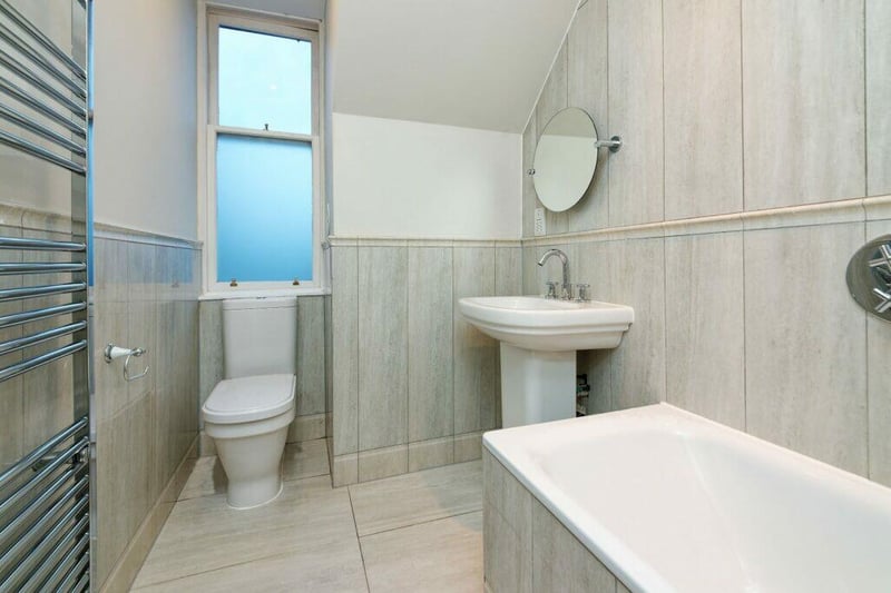 The main bathroom features a freestanding bath with shower overhead. 