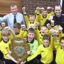 Meadowhall Junior School's football team with the Rotherham Junior School Cup trophy. Pictured with the boys are Malcolm Rhodes (left) and Richard Pease (right), who coach and manage the team.