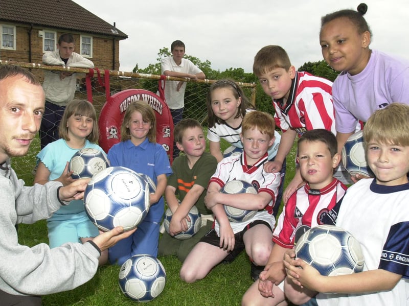 Mark Holmes, Gavin Dunn and Ben Shadbolt, of the Sheffield United Football in the Community programme, pictured with some of the children from Hartley Brook, Hatfield, Hucklow and Beck junior schools who tool part in a football training session at Hartley Brook School