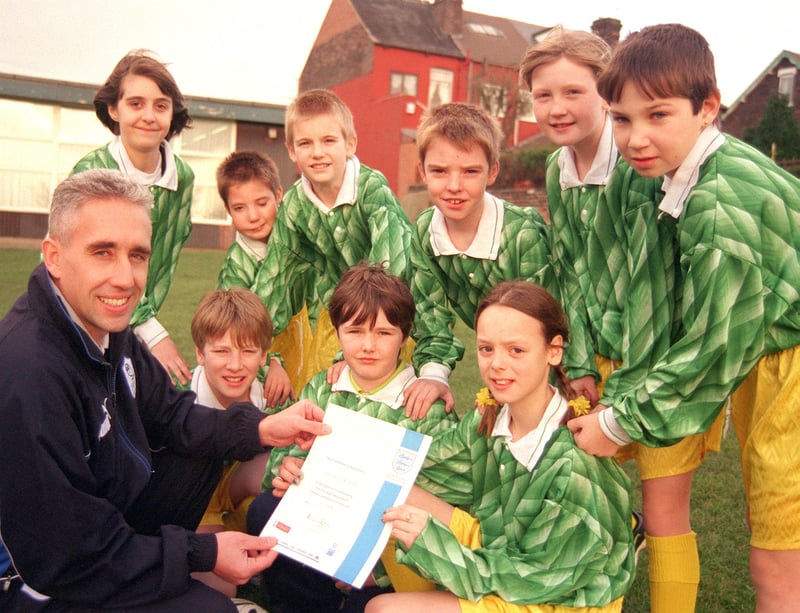 Aston Fence Junior and Infants School headteacher and soccer coach Darren Clegg with the school's certificate from the Football Association. Looking on are some of the pupils.