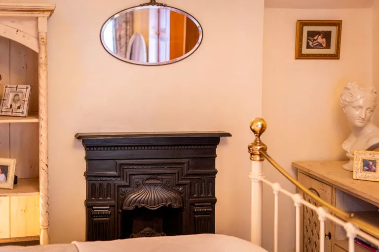 The room benefits from a gorgeous cast iron fireplace.