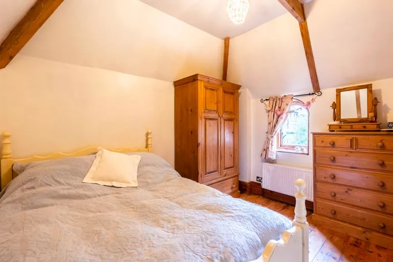 A second double bedroom with exposed beams can be found on the first floor.