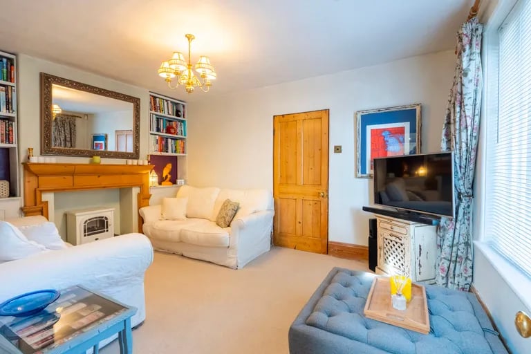 On the ground floor is a generous size living room with fireplace.