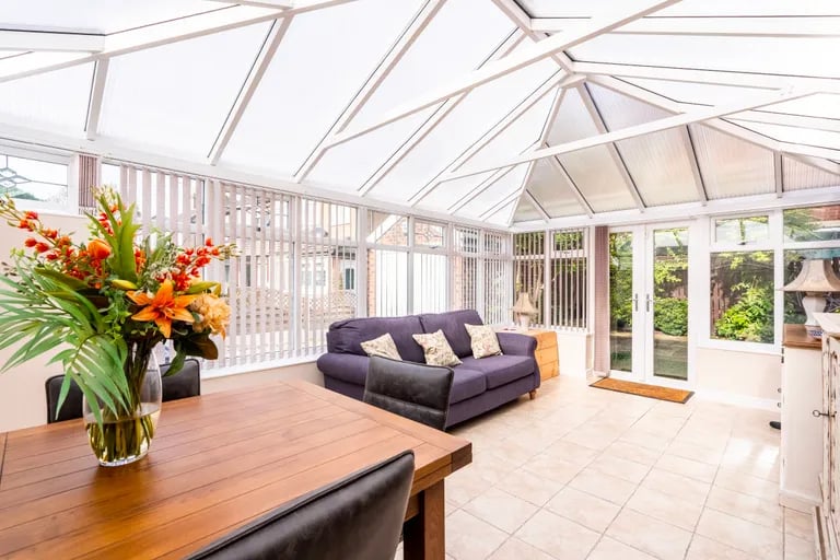 This spacious room with access to the rear garden can serve as a second living room.