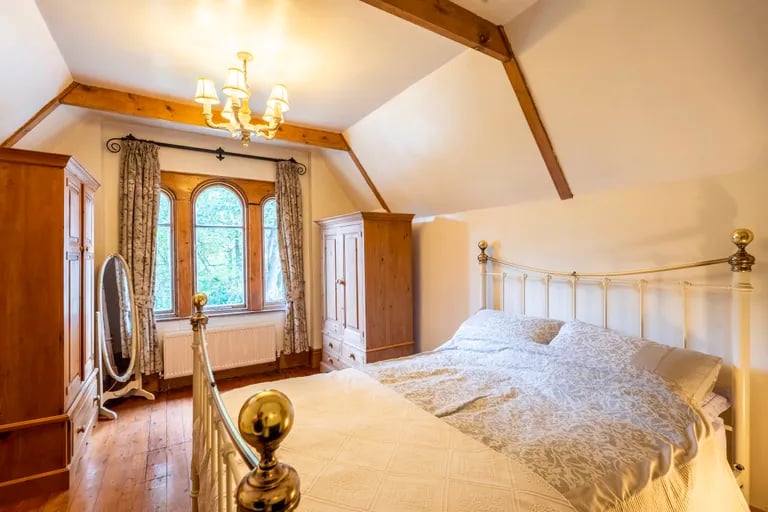 Here is a stunning double bedroom with exposed beam and large window.