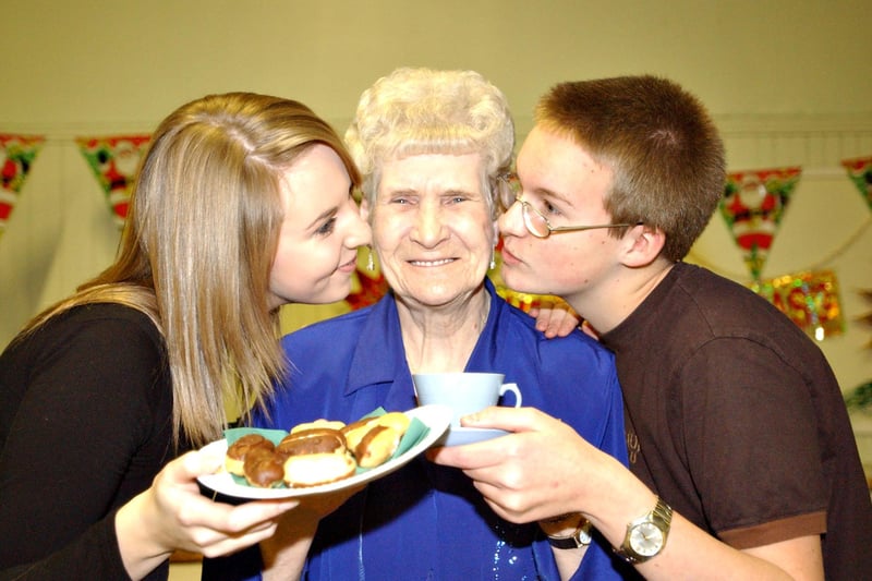 Margaret Tyson was treated to a Christmas tea by Sunderland High School students Kristina Huntley and David Lockwood in 2003.