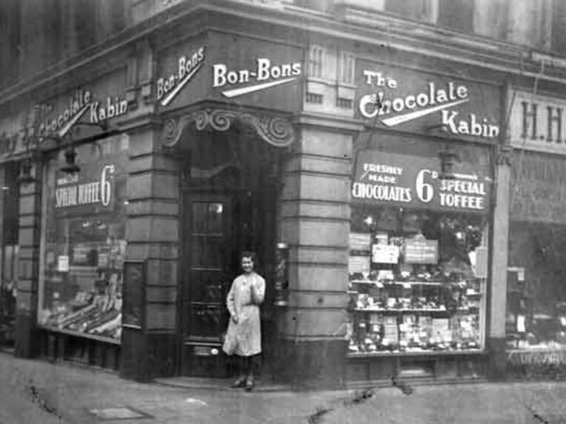 Ivy Clow (later Yates) outside Thornton's Chocolate Kabin on the corner of Howard Street and Union Street, Sheffield city centre, in 1920.
She was just 16 years old when this photograph was taken and was most likely the first assistant in the shop, later becoming a supervisor at Thornton's confectioners.