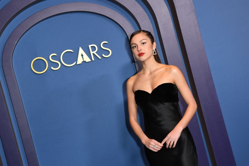 Olivia Rodrigo looked incredibly stylish in a black YvesSaint Laurent fall 1997 couture gown. A slick of red lipstick completed her look.