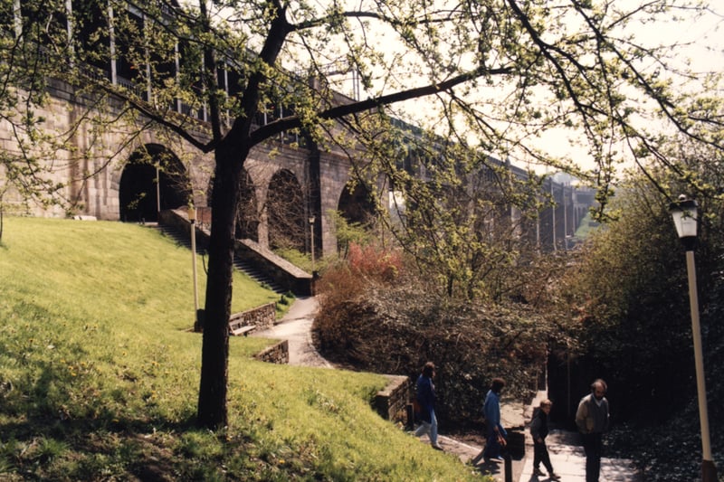 A view of Long Stairs Newcastle upon Tyne taken c.1990. The photograph shows the landscaping of the land on either side of the Long Stairs which took place after the demolition of the houses. The High Level Bridge is in the background.