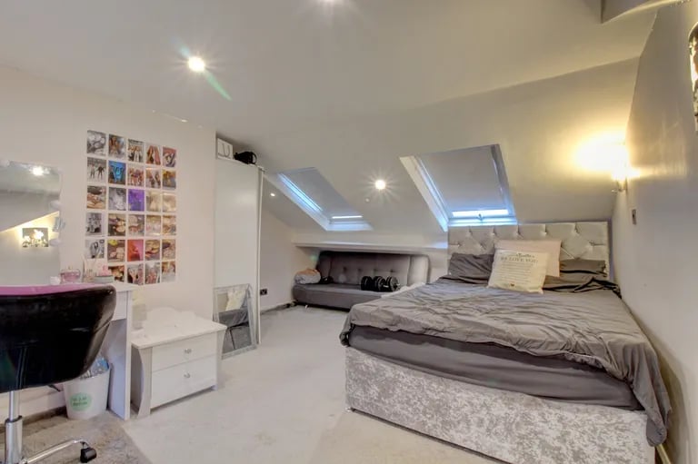 On the second floor is a large double bedroom with skylight windows.