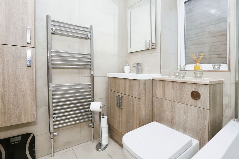 The main bathroom includes a bath and heated hand rail.