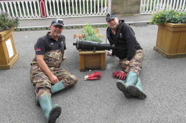 L-R Steve Forrest and Glen Collins, of The Peaky Dippers, pictured with the cannon found in the River Don in Sheffield.