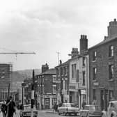 Howard Street in 1964, showing premises including C. H. Harrington and Co sheet metal workers, T.H. and N. Perkins bakers, Mary Gentle Cafe, Milners house furnishers and Globe Inn