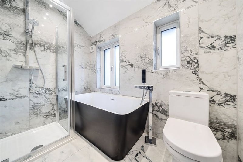 The house bathroom features a charming bathtub and separate shower.