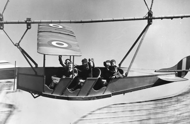 Young evacuees from Manchester and Salford enjoying themselves on the aeroplane ride pretending to bomb Berlin, at Blackpool Pleasure Beach