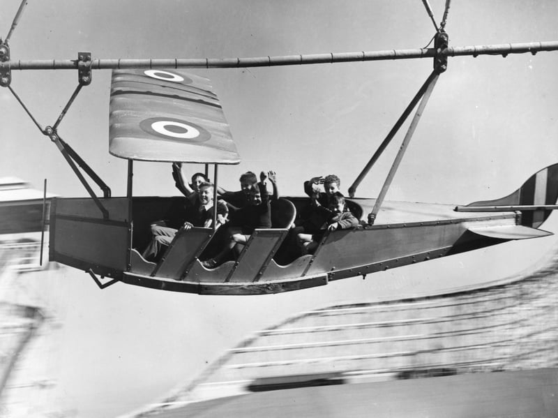 Young evacuees from Manchester and Salford enjoying themselves on the aeroplane ride pretending to bomb Berlin, at Blackpool Pleasure Beach