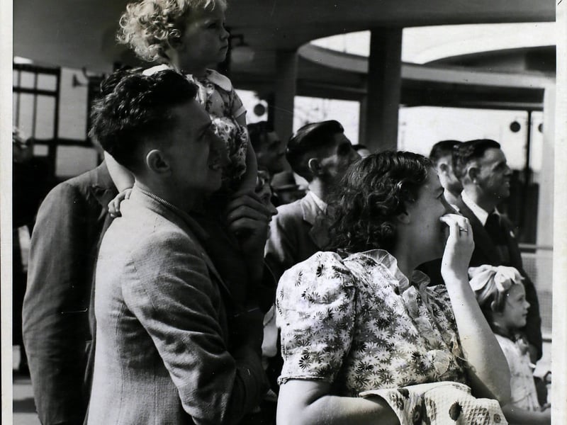 Holidaymakers make a fine study in expressions whilst watching one of the amusements in the Pleasure Beach. 1950s?