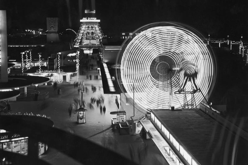 Illuminated rides at The Pleasure Beach in Blackpool, including a ferris wheel and the Big Dipper, 10th September 1955