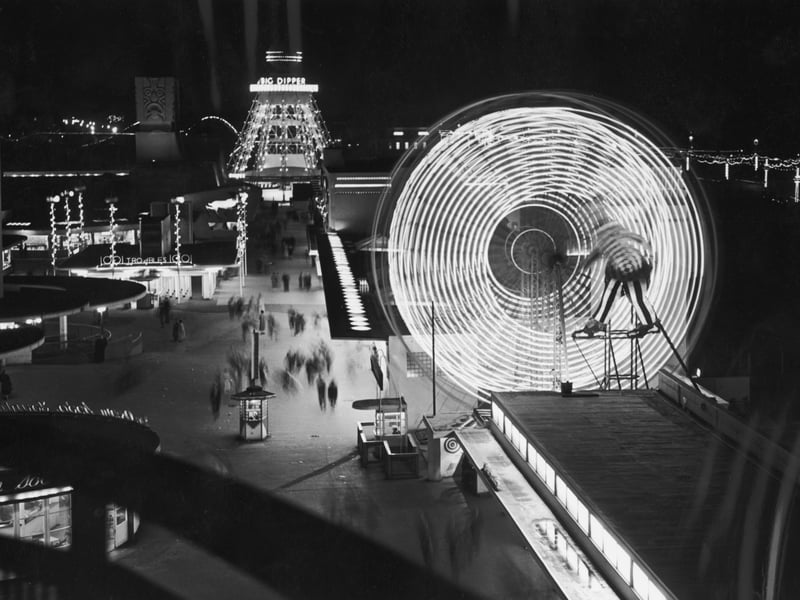 Illuminated rides at The Pleasure Beach in Blackpool, including a ferris wheel and the Big Dipper, 10th September 1955