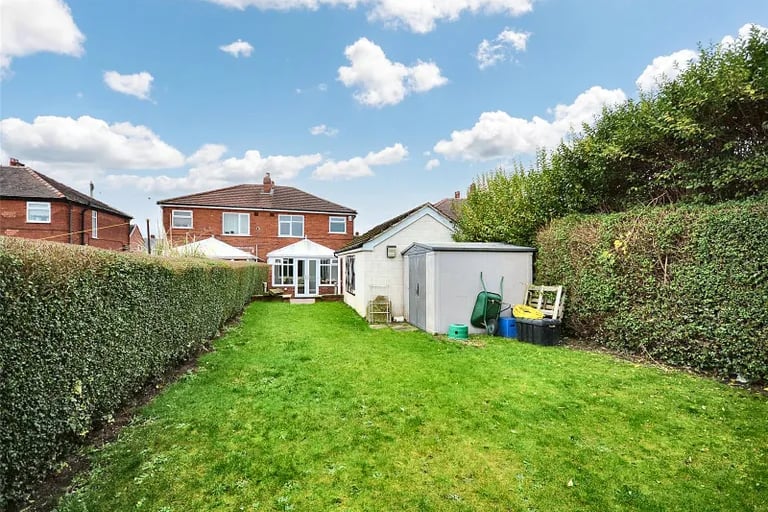 Externally is an enclosed garden with block paved patio seating area, lawn and garden shed.