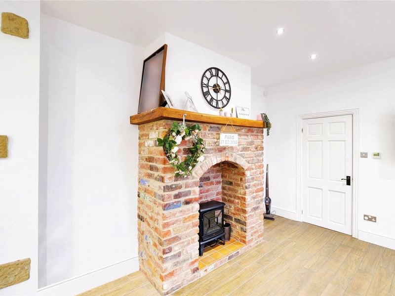 A quieter sitting room is found next to the kitchen and features this charming fireplace. (Photo courtesy of Zoopla)