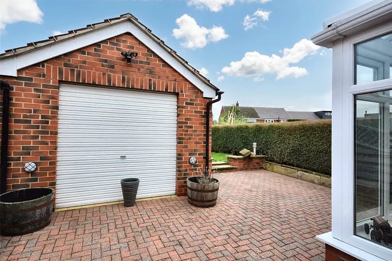The detached single garage is ideal for parking and storage.