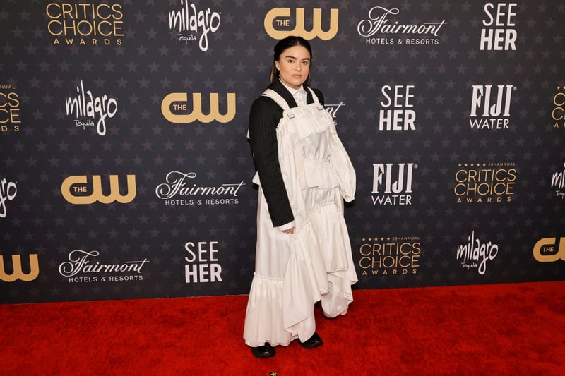 Oh dear oh dear. Devery Jacobs chose to wear a white dress over a black suit to the Critics' Choice Awards in 2023