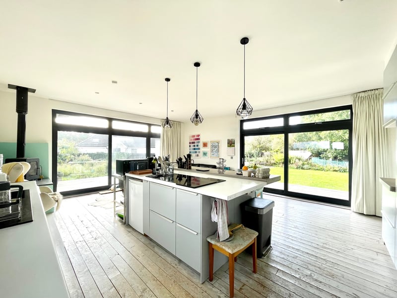 Interior: Silverwood’s ground floor offers a large lounge with French doors to wrap around decking, an open-plan kitchen/family room, an office, guest bedroom, and study. Upstairs is a spacious landing and the other three bedrooms.
