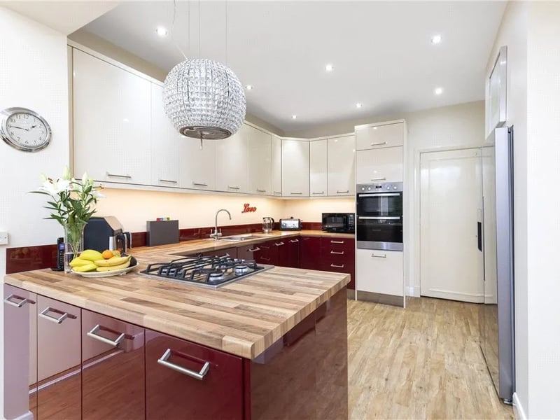 The spacious kitchen has a range of base and wall units.