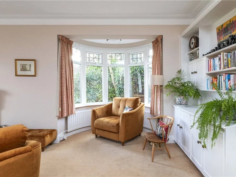The living room has a charming bay window.