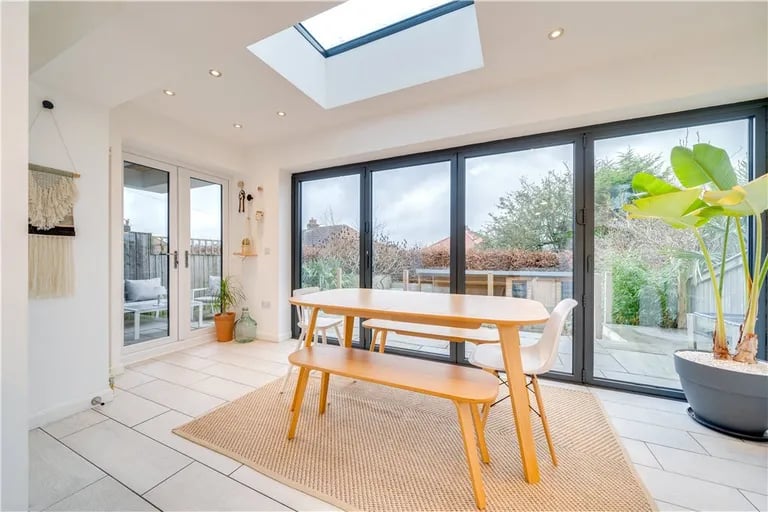 It opens to the dining area with a large window overlooking the rear garden and access to the terrace.