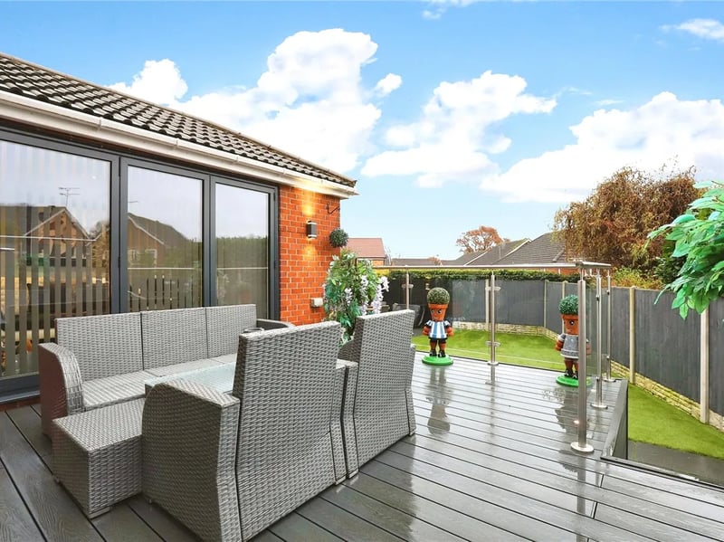 The elevated decking area offers an excellent point to sit and watch as youngsters play on the grass. (Photo courtesy of Zoopla)