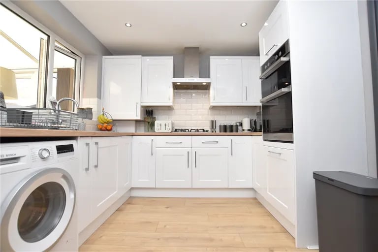 The fitted kitchen has a range of base and wall units.