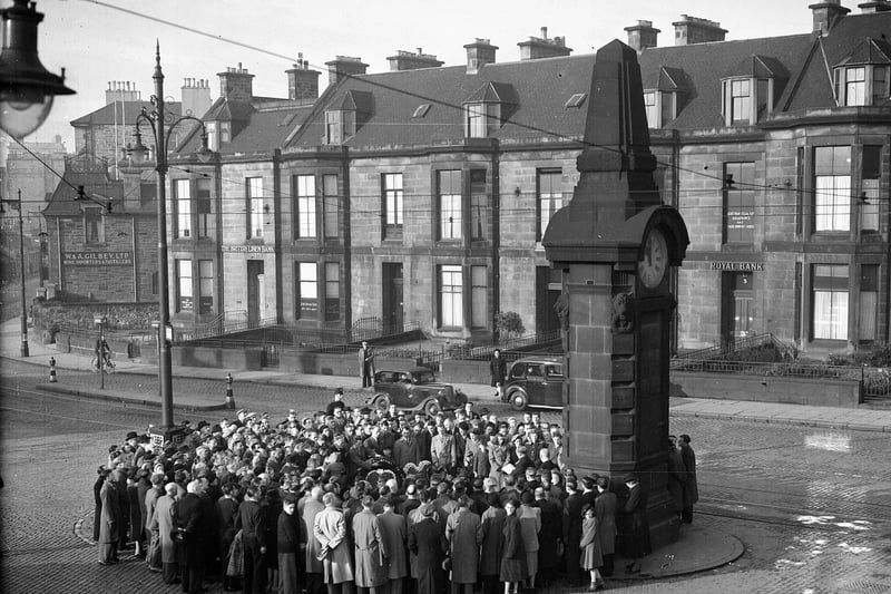 Crowds gather around the Heart of Midlothian War Memorial clock at Haymarket on Remembrance Day 1950 to commemorate the Hearts players who died during the First World War.