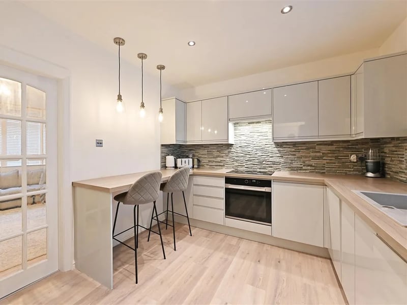 The kitchen has a lovely breakfast bar and plenty of storage. (Photo courtesy of Zoopla)