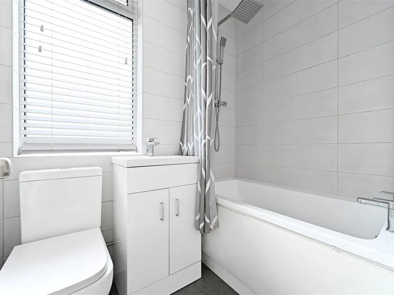 The bathroom has a toilet, sink and shower/bath. (Photo courtesy of Zoopla)