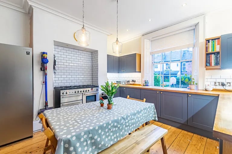 The kitchen mixes modern stylish units with the character of the home.