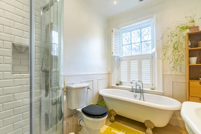 The house bathroom keeps with the era of the home with a roll-top bathtub.