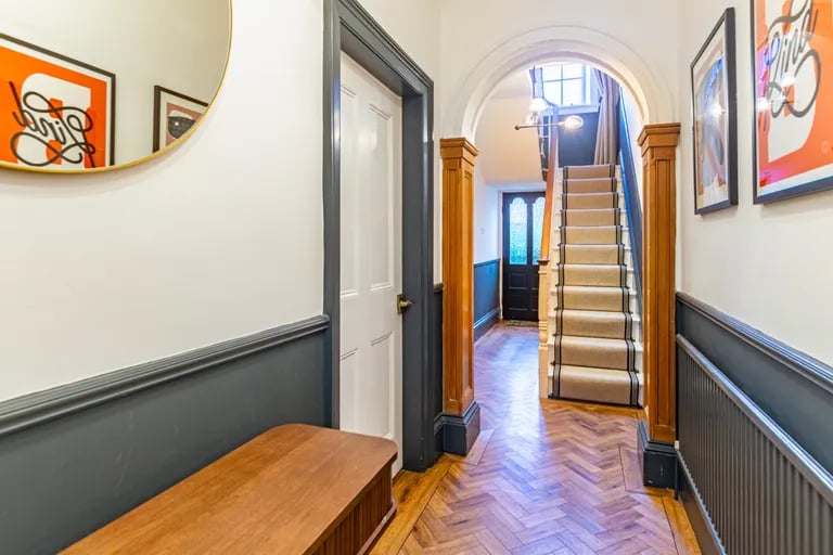 Enter into an elegant hallway with lots of character features.
