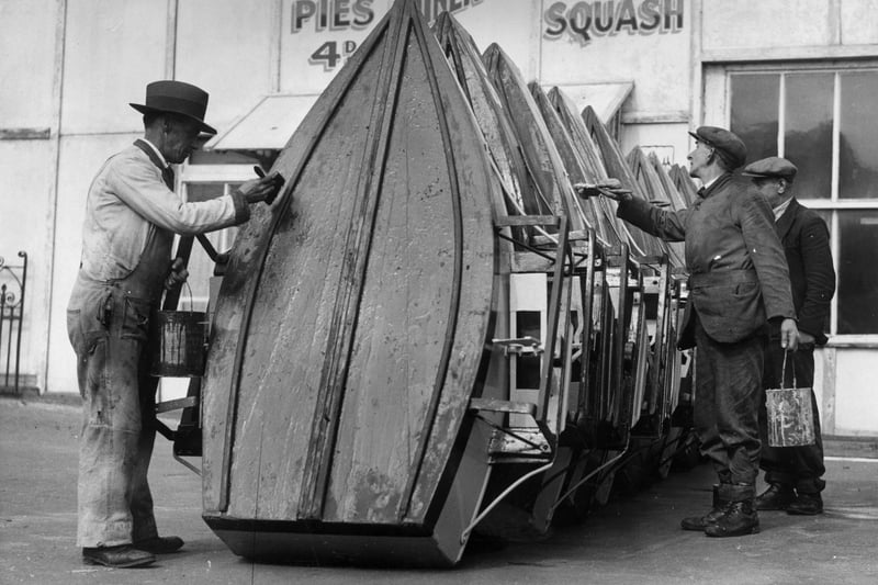 31st March 1936:  Men painting the pleasure boats at Blackpool Boating Lake,  Blackpool Pleasure Beach, Lancashire, in preparation for the Easter holiday visitors.  (Photo by Arthur Tanner/Fox Photos/Getty Images)