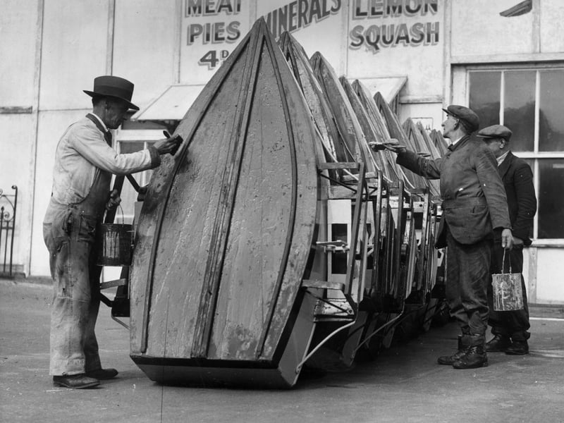 31st March 1936: Men painting the pleasure boats at Blackpool Boating Lake, Blackpool Pleasure Beach, Lancashire, in preparation for the Easter holiday visitors. (Photo by Arthur Tanner/Fox Photos/Getty Images)