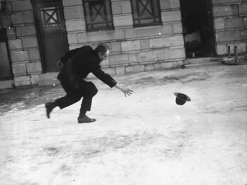 14th December 1937: A visitor to Blackpool chases his hat along the promenade in gale force winds. (Photo by Fox Photos/Getty Images)