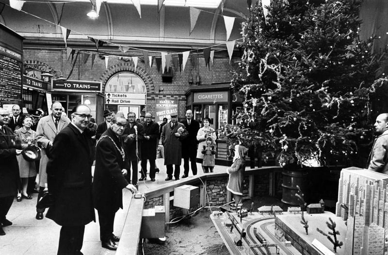 The Lord Mayor of Sheffield (Ald. Dan O'Neill) pictured switching on the Christmas lights at the Midland Station, with Mr Kenneth Robinson (asst station manager) and officials looking on, in December 1969
