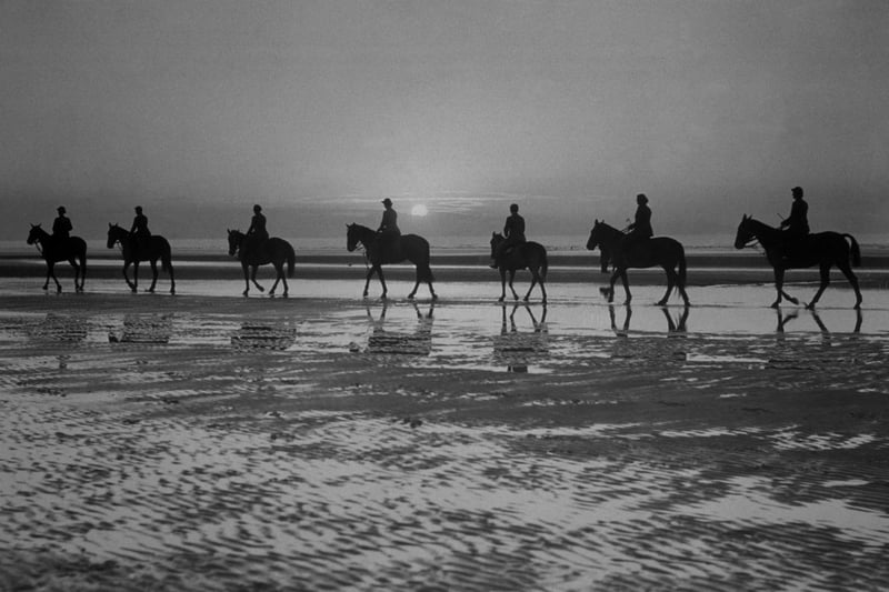 circa 1937:  Horse riders on Blackpool beach, silhouetted against the evening sky.  (Photo by Fox Photos/Getty Images)